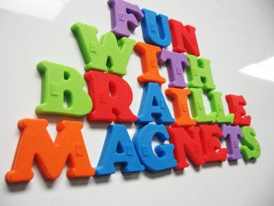a variety of letter magnets with Braille on them. The magnets spell out "Fun with Braille Magnets"